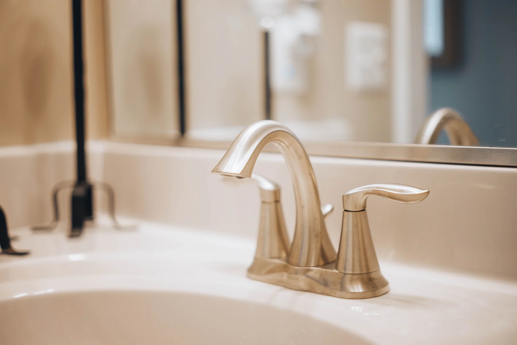 Stainless-steel faucet above a white sink